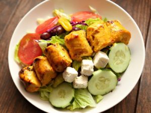 Chicken, cucumbers, tomato, and olive salad