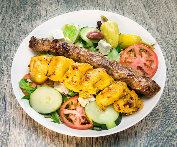 White meat, red meat, salad with cucumbers, peppers and feta cheese and lettuce