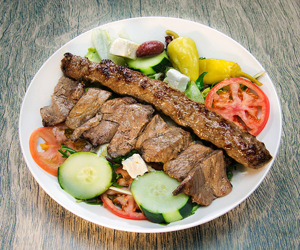 Two different types of red meat and a salad combo meal