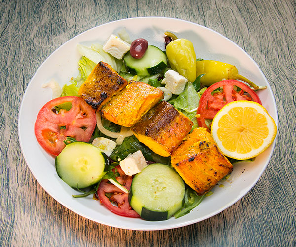 Salmon salad with lemon, tomatoes, and lettuce