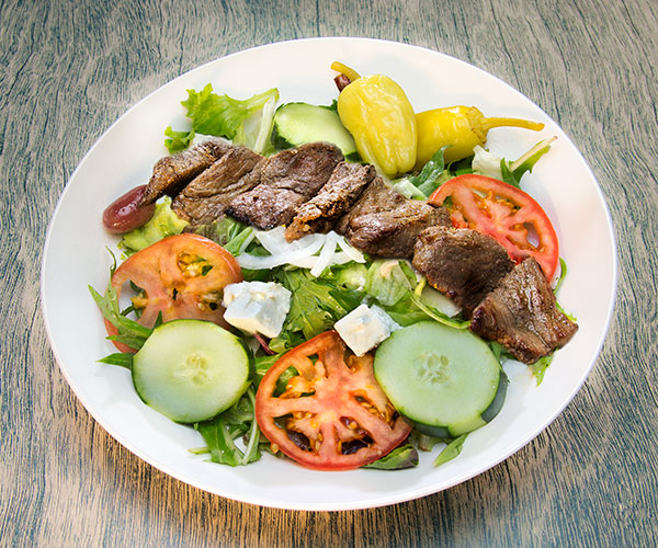 Barreh salad, consisting of meat and cucumbers, tomatoes, peppers, and cheese