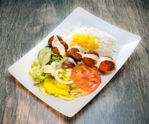 Falafel and rice salad with peppers, lettuce, tomato, cucumber, and olives