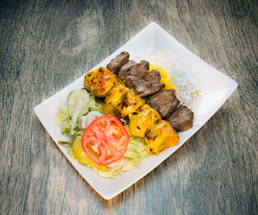 A super combo meal consisting of beef or lamb served over half a portion of rice and half a portion of salad.