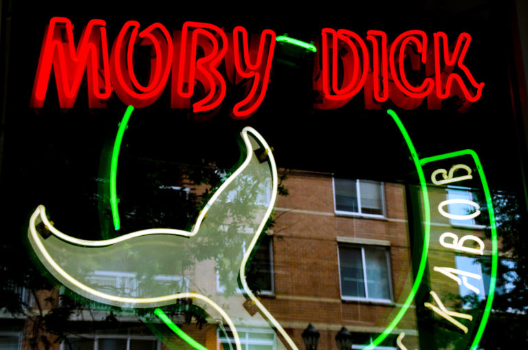 The illuminated sign at Moby Dick's Arlington location